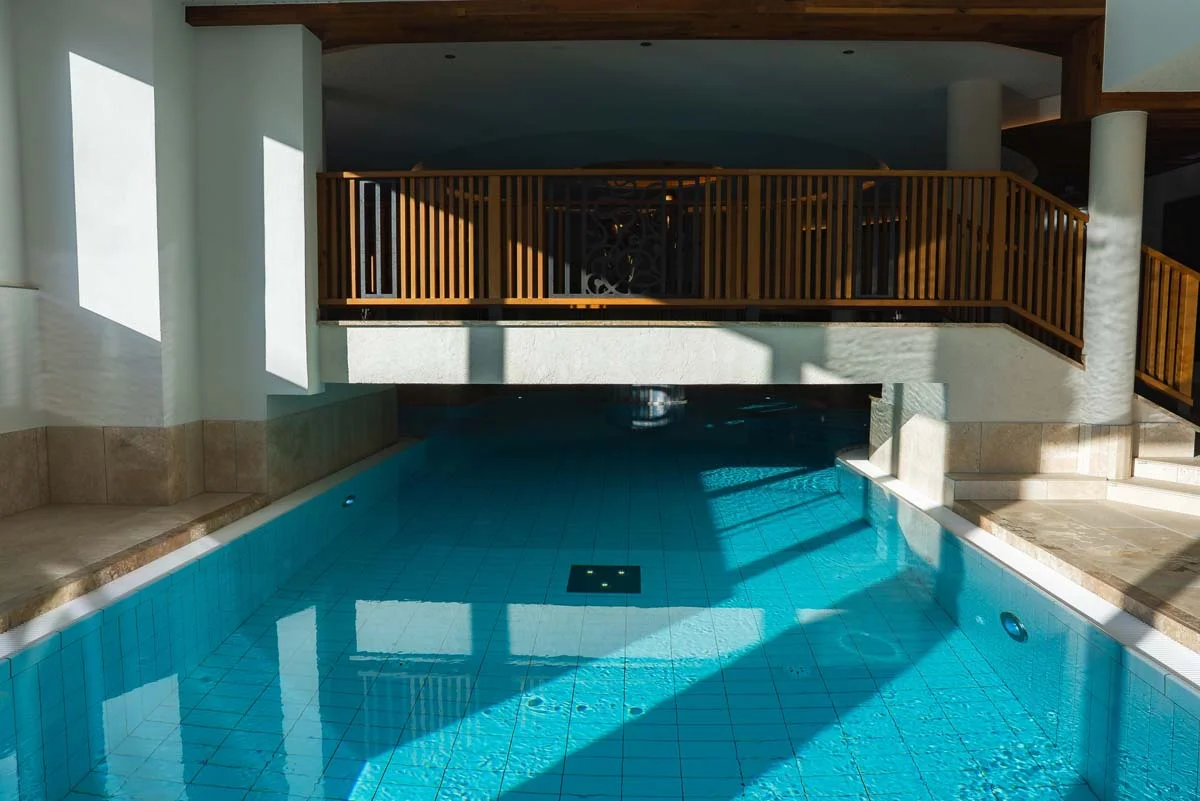 Luxury indoor swimming pool amenity with modern design and large windows in a high-rise residential building