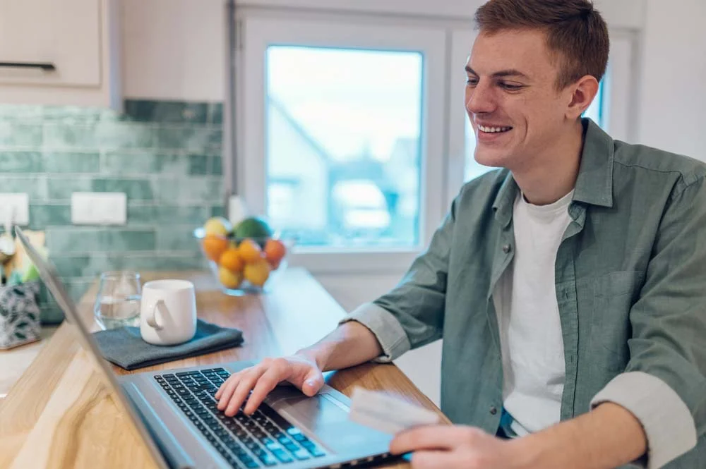 Applying for an Airbnb business license in Toronto with laptop and documents