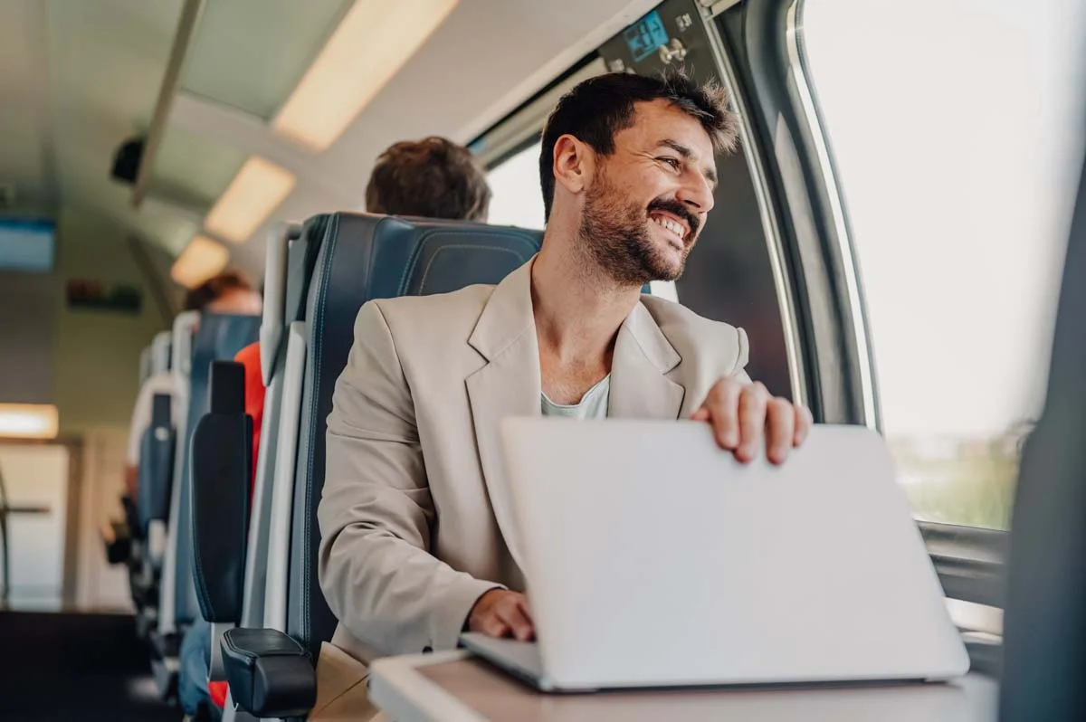 A remote property owner comfortably managing their rental property from a different city using a laptop