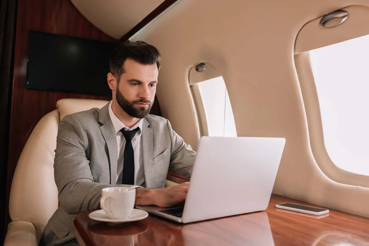 A traveling business professional working from a laptop