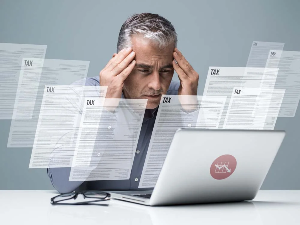 Person looking confused while comparing a Seattle Business License Tax Certificate and a business license