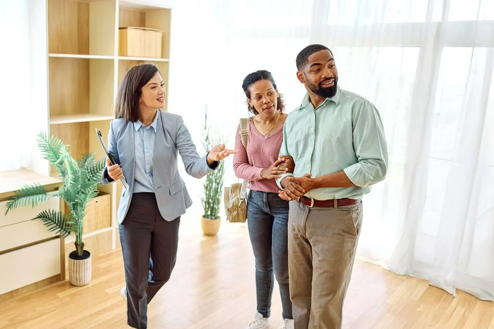 A property manager helping a guest by explaining house rules and safety guidelines in a clean vacation rental