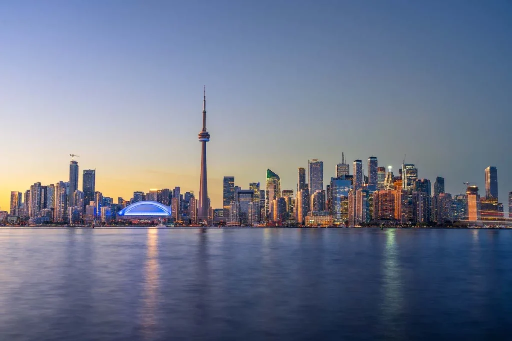 A beautiful view of the Toronto city skyline with modern buildings under a clear blue sky