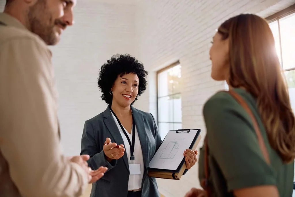 A friendly property manager with happy guests in a modern living room