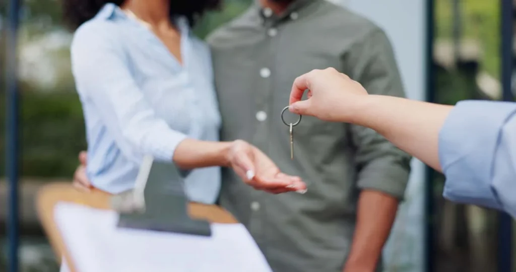 A homeowner handing over keys to start a property management partnership in Lighthouse Point
