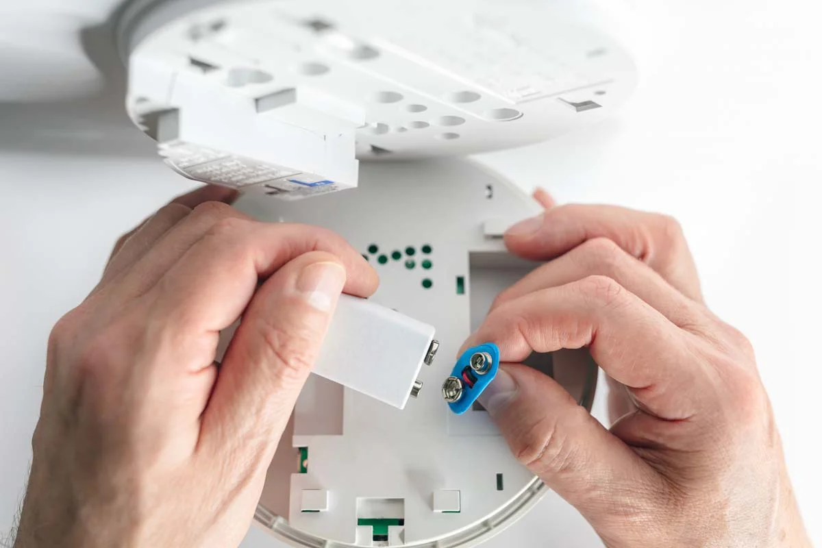 A professional fire and smoke alarm installed in a vacation rental for safety compliance