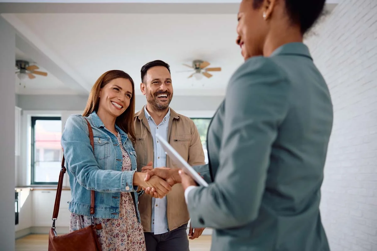 A property owner and an Airbnb rental manager handing over keys to a rental home