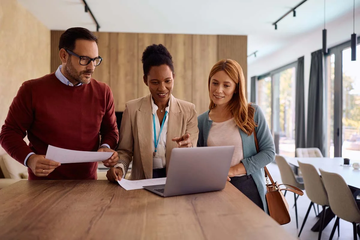 A property vacation rental management team doing Pompano Beach compliance tasks on a laptop
