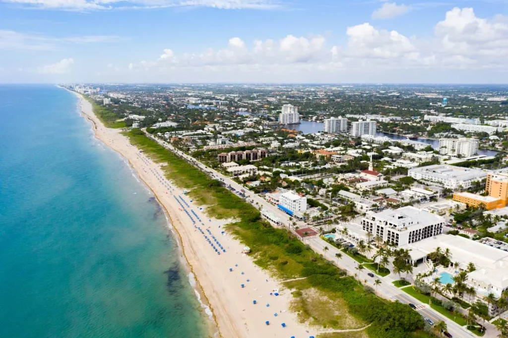 A scenic aerial drone photo of Delray Beach, Florida, showcasing luxury mansions and high-value properties