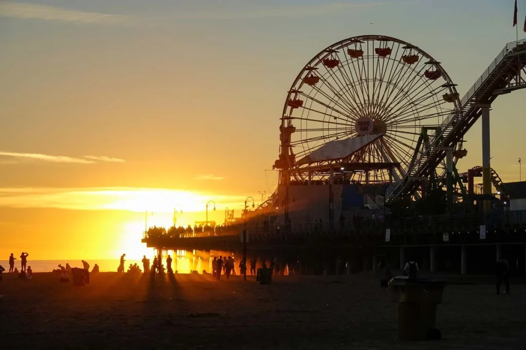 A sunny day at the Santa Monica beach with the pier and Ferris wheel in the background