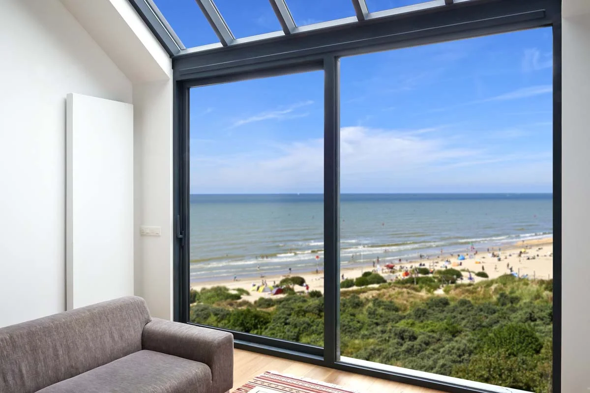 A vacation rental home with large windows overlooking the beach, representing Airbnb property management in Broward County
