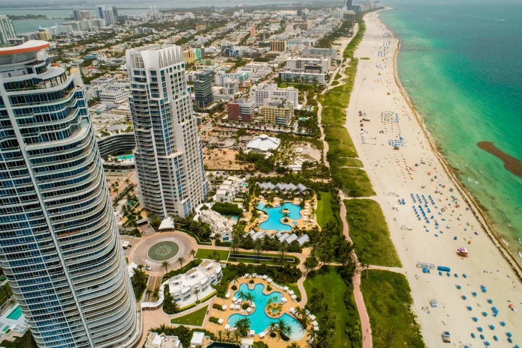 Aerial view of luxury Miami Beach condos along the oceanfront, ideal for short term rental investments