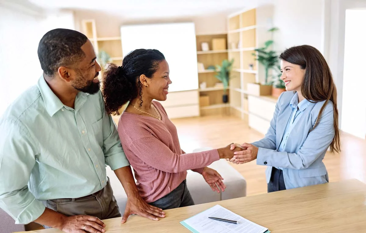 An Airbnb management expert shaking hands with happy property owners
