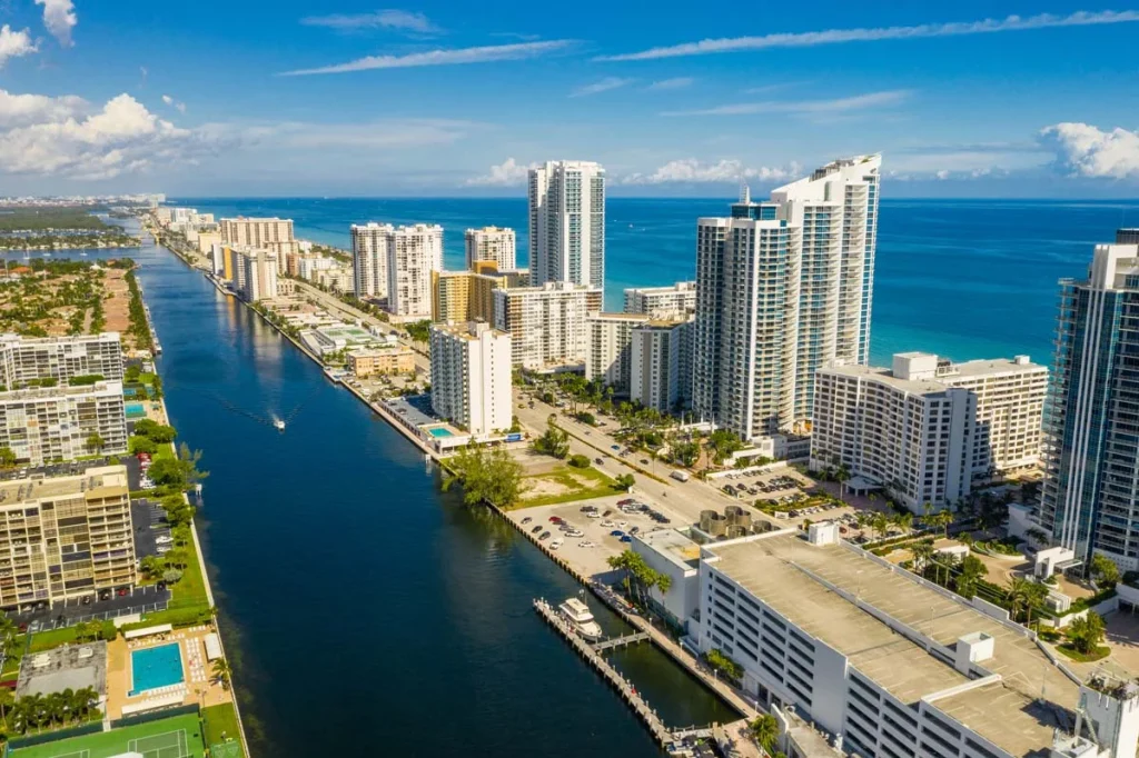 An aerial shot of vacation homes and nice condo buildings with blue skies and palm trees