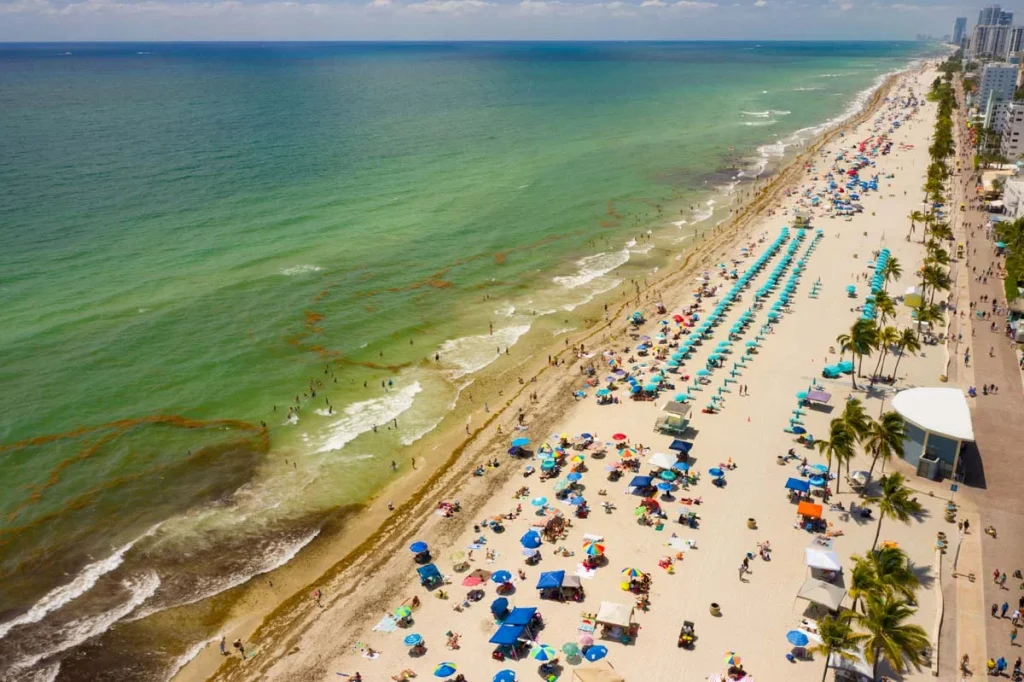 An aerial view of the beautiful Hollywood Beach, Broward County coastline and beaches, highlighting the local tourism market