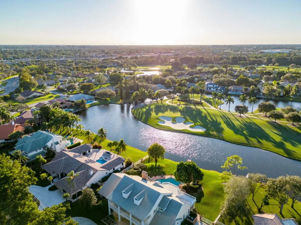 Beautiful homes in Plantation, Florida with green grass and palm trees