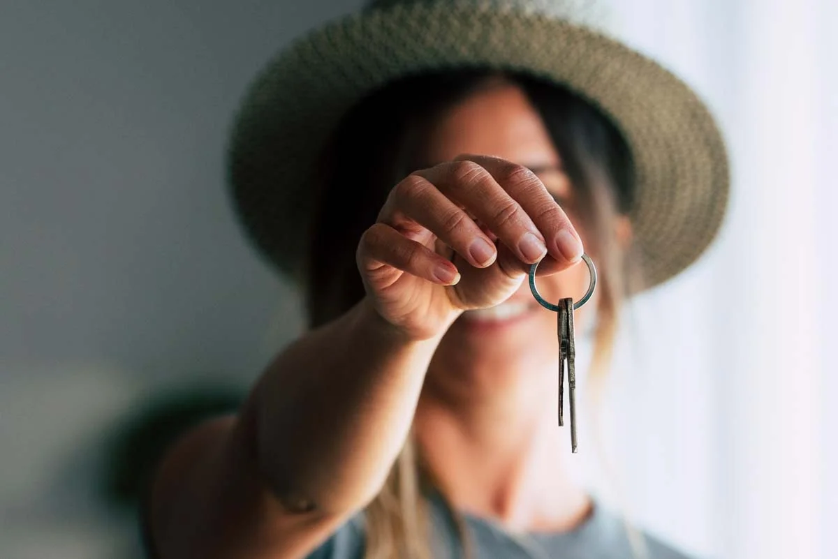 Close-up of a property owner holding keys to symbolize a property management partnership