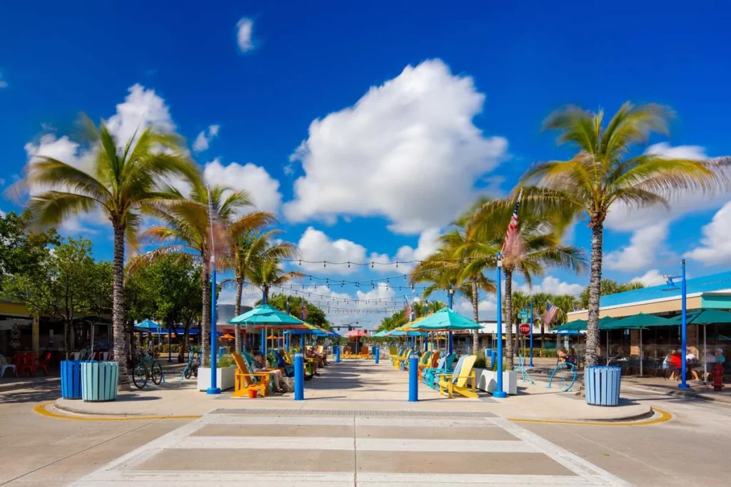 Colorful chairs sitting area with palms in Lauderdale By The Sea Commercial Beach