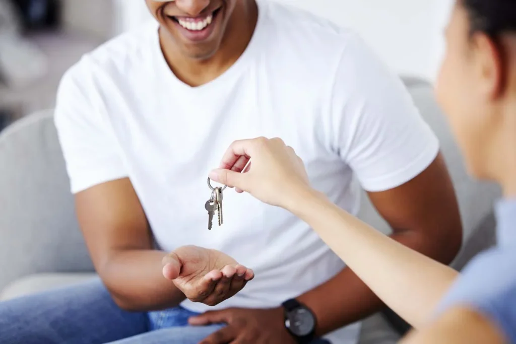 Homeowner handing over keys to a professional property management service