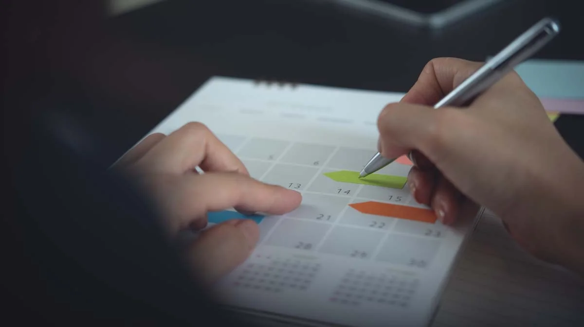 Person managing short term rental bookings on a calendar