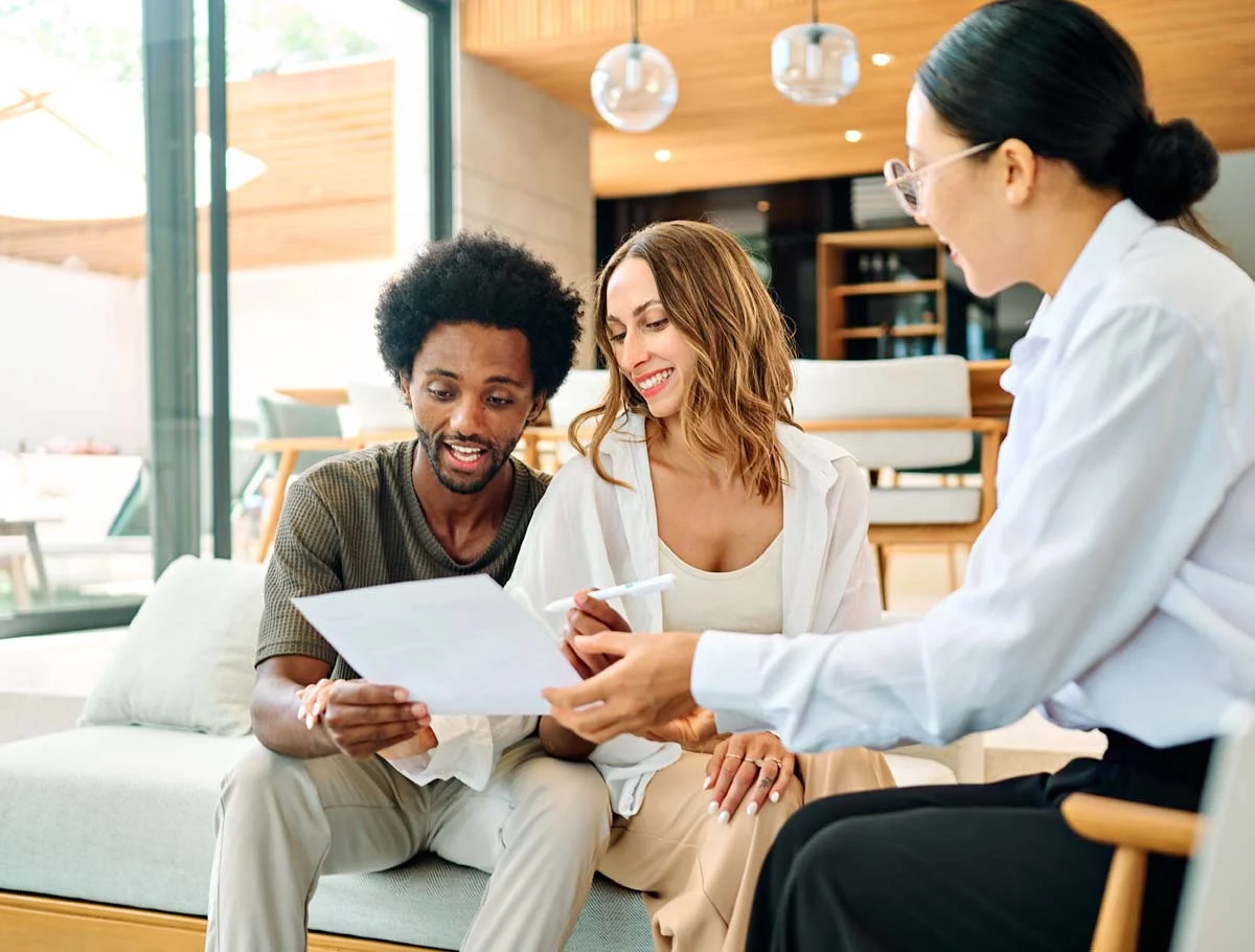 Professional property manager and a homeowner discussing rental strategy in a bright, modern living room