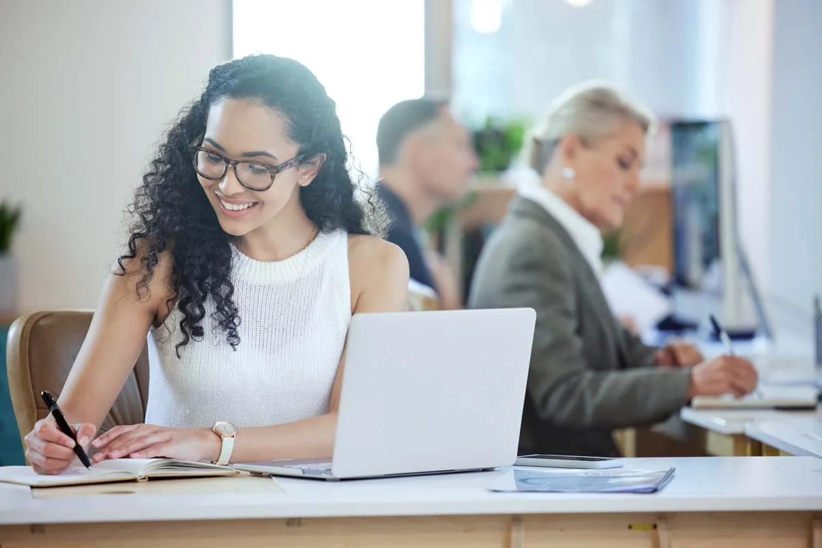 Professional vacation rental manager working on a laptop in a bright office