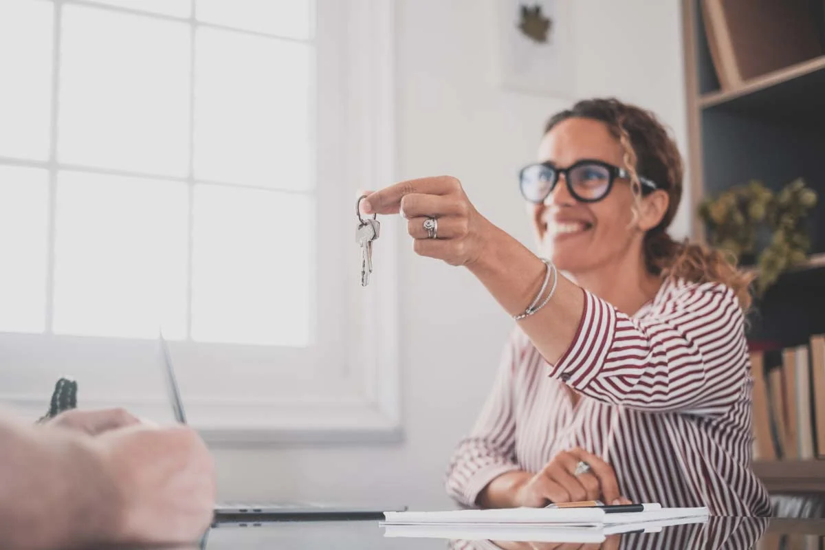 Property manager giving house keys to a guest of a short term rental property