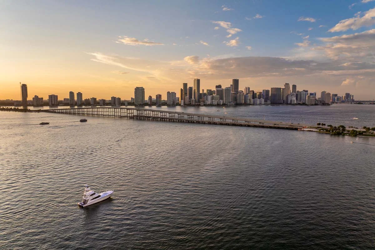 The Miami skyline and Biscayne Bay at sunset featuring modern glass high-rise condos