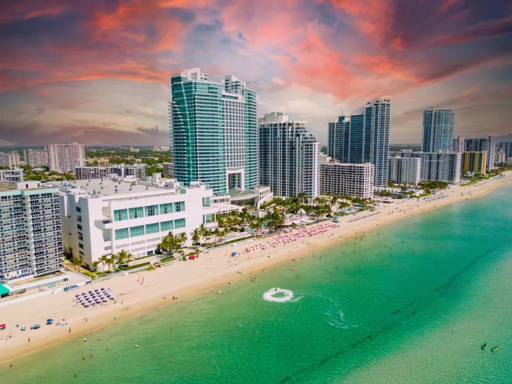 Beautiful sunny beach with palm trees and ocean waves in Florida