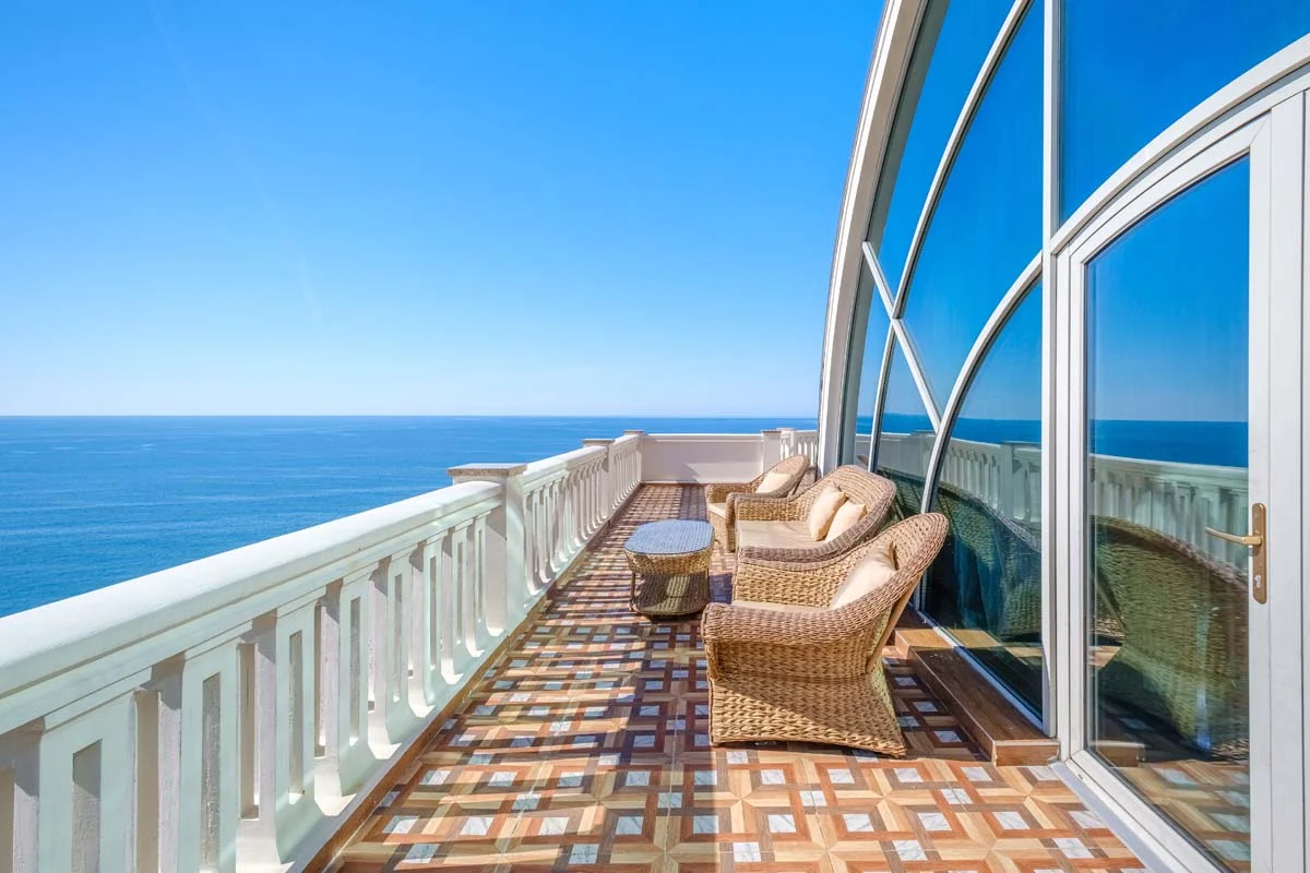 A balcony view from a luxury condo overlooking the water