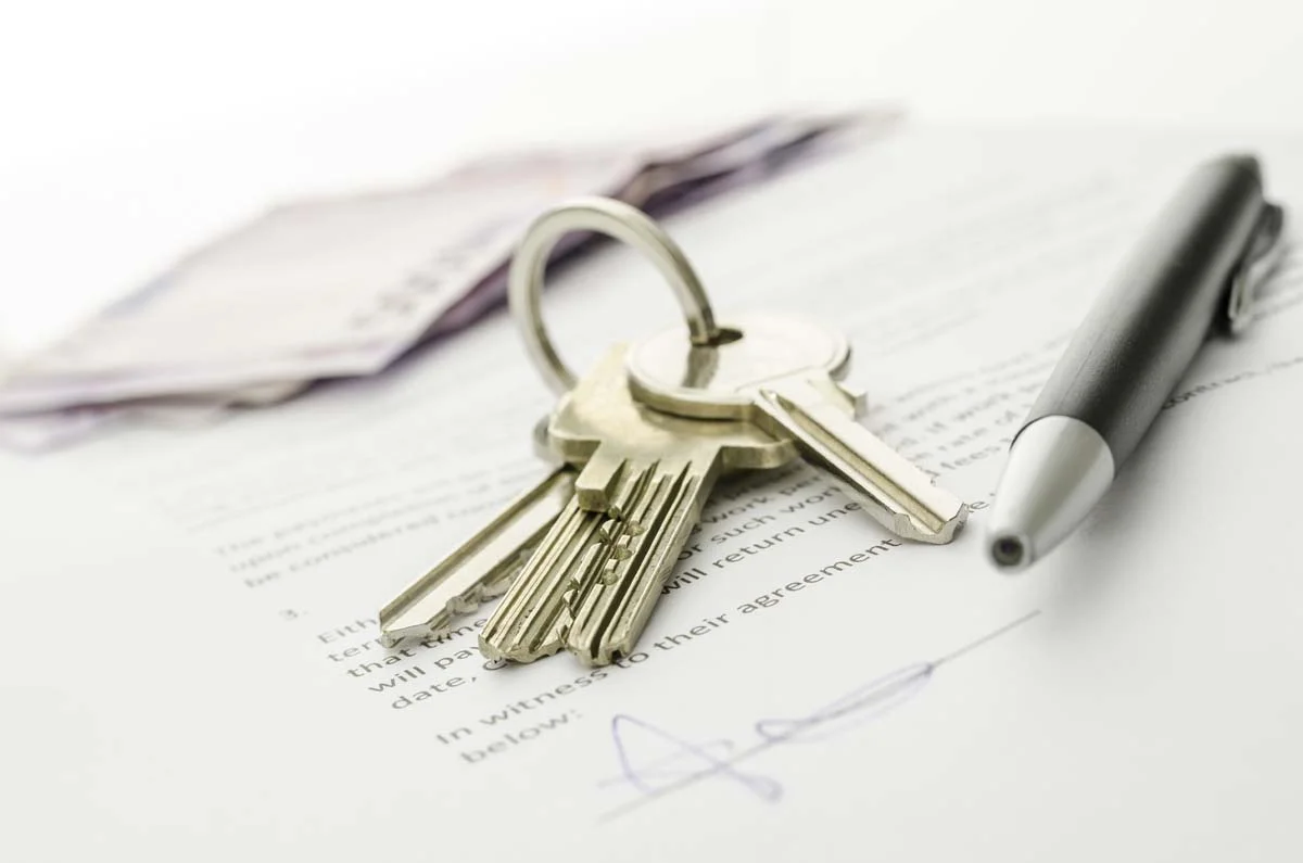 A business permit and property keys on a desk representing Redmond short term rental compliance