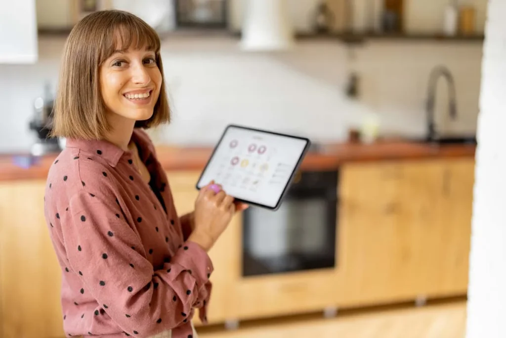 A happy property owner using a tablet to manage their vacation rental income