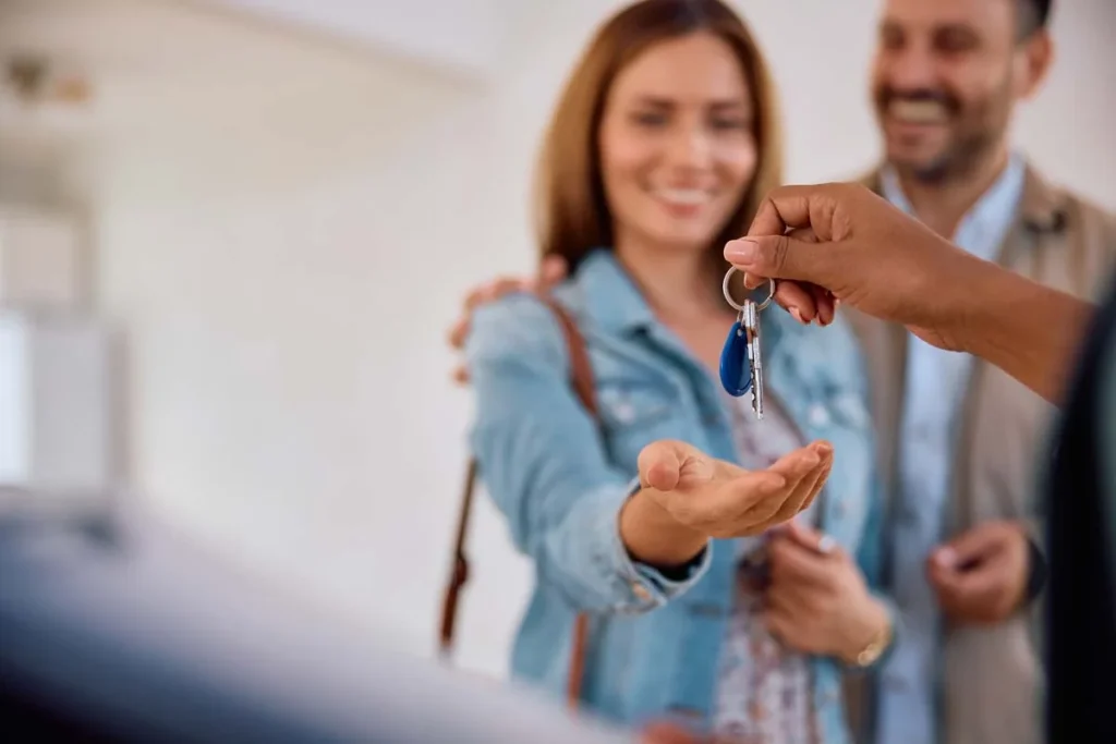 A professional Airbnb property manager giving house keys to guests of a Bahamas rental home