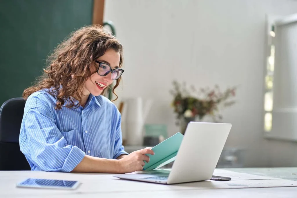 A professional property manager using a laptop to manage an Airbnb in San Jose