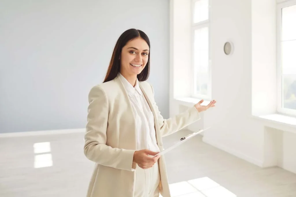 A property manager happily showing the interior of a vacation home rental