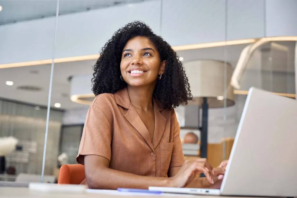A property manager using a laptop to handle guest communications for a short term rental