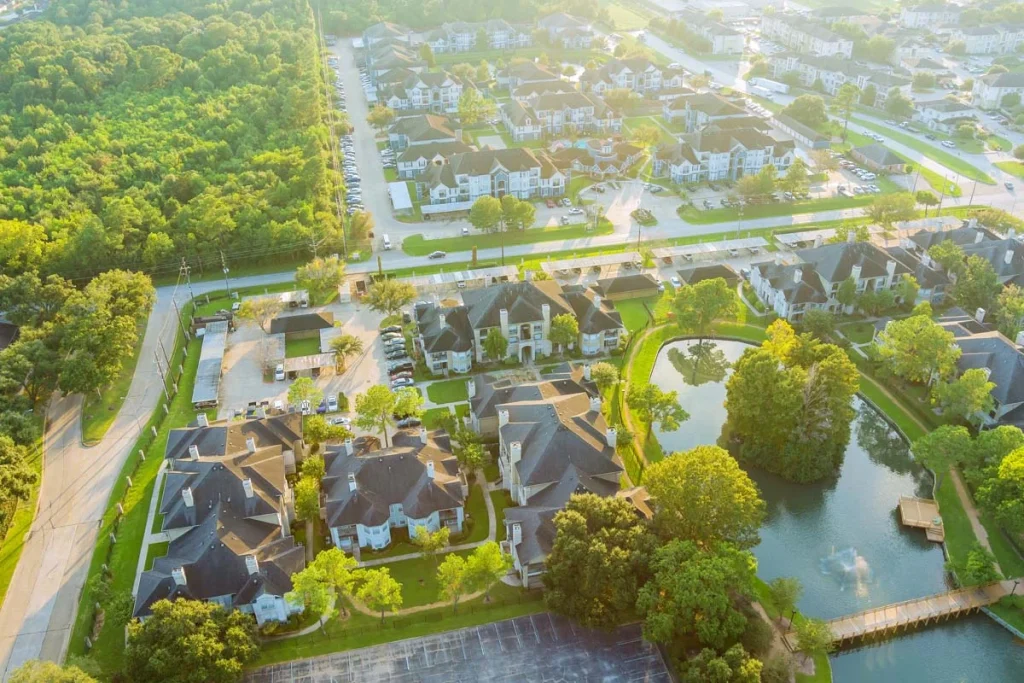 A quiet, tree-lined residential street in a popular Houston neighborhood featuring well-maintained homes