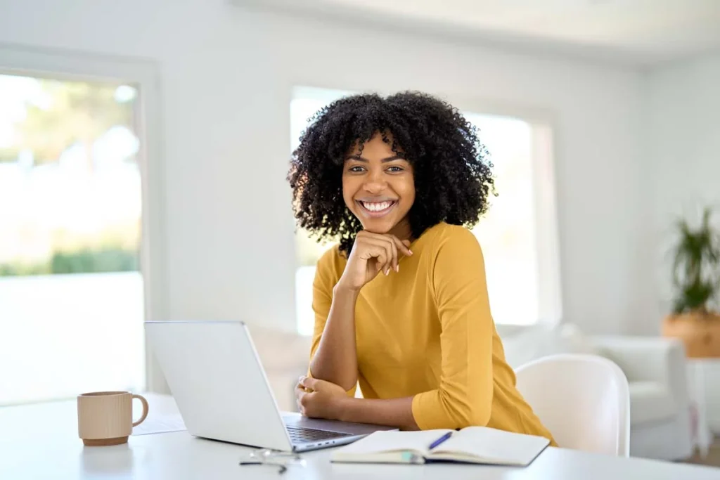 A relaxed homeowner enjoying coffee while looking at a tablet in a bright, modern home