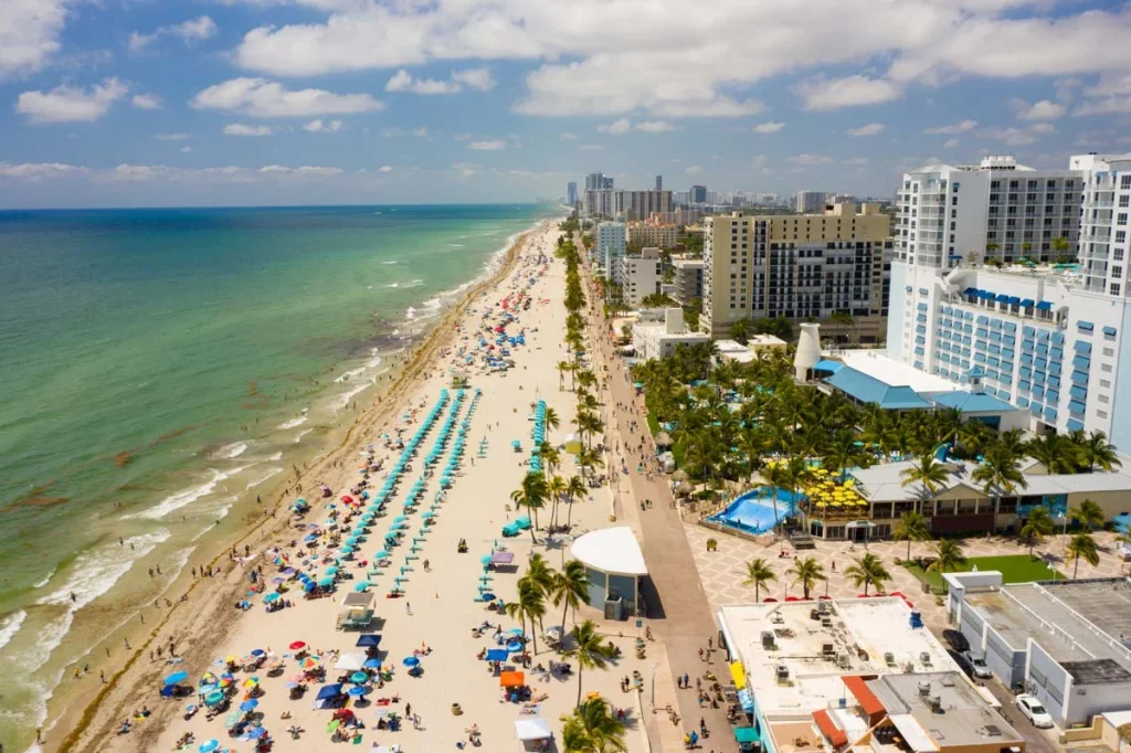A sunny view of the Hollywood Beach and ocean, showcasing the desirable location for short term rentals in Hollywood Florida