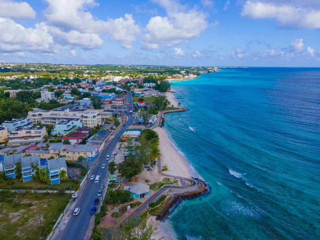 A vibrant outdoor scene showing local architecture and coastal views in Christ Church