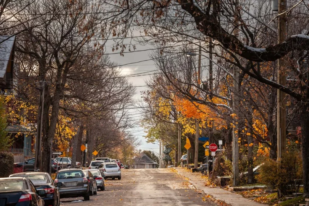 An autumn afternoon, featuring cars parked and single-family unit houses in a suburban atmosphere of Caledon’s residential charm