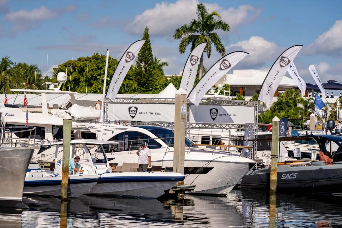 Attendees viewing luxury yachts docked at the Fort Lauderdale International Boat Show