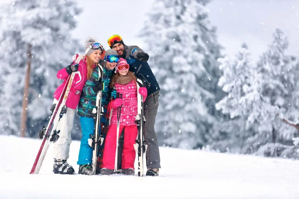 Family together skiing on snowy mountain in a skiing resort near The Blue Mountains
