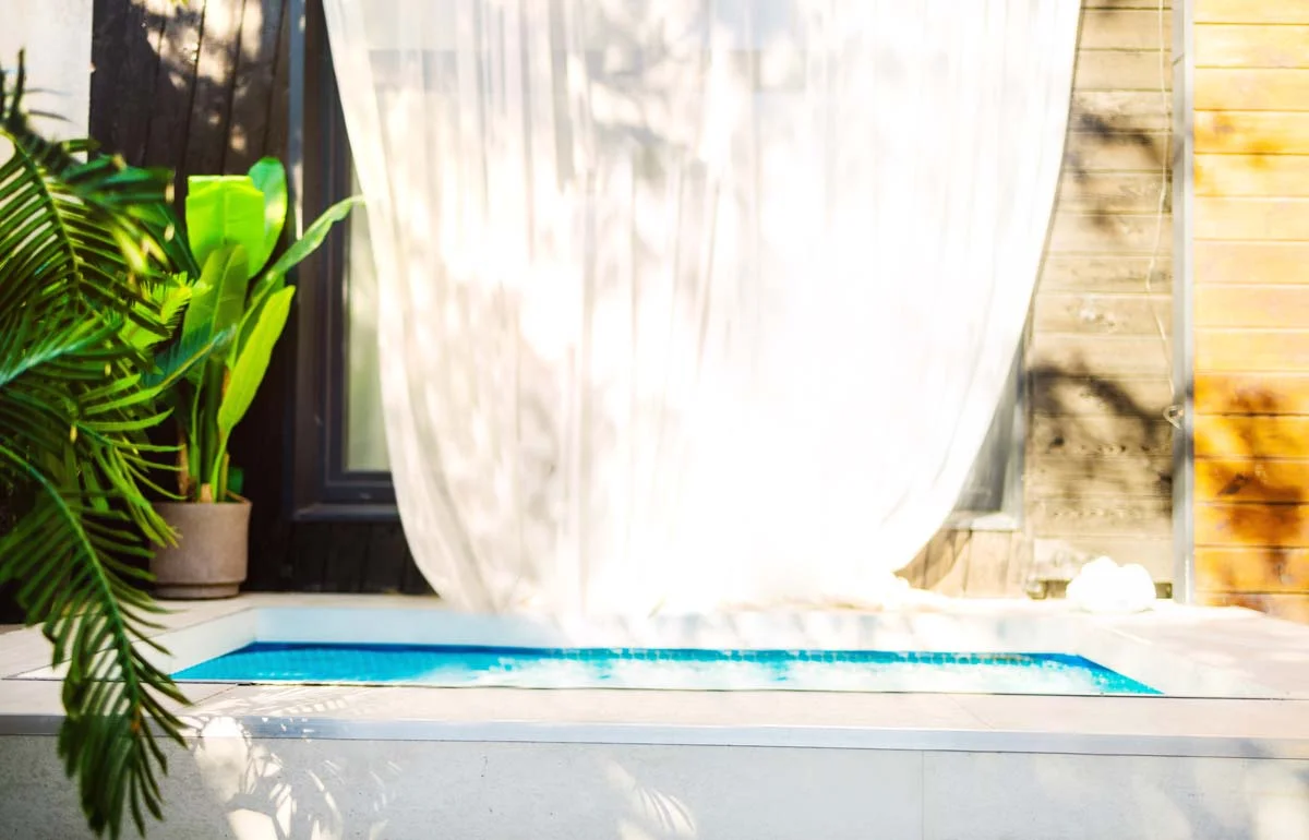 Modern luxury vacation rental home with a pool at sunset