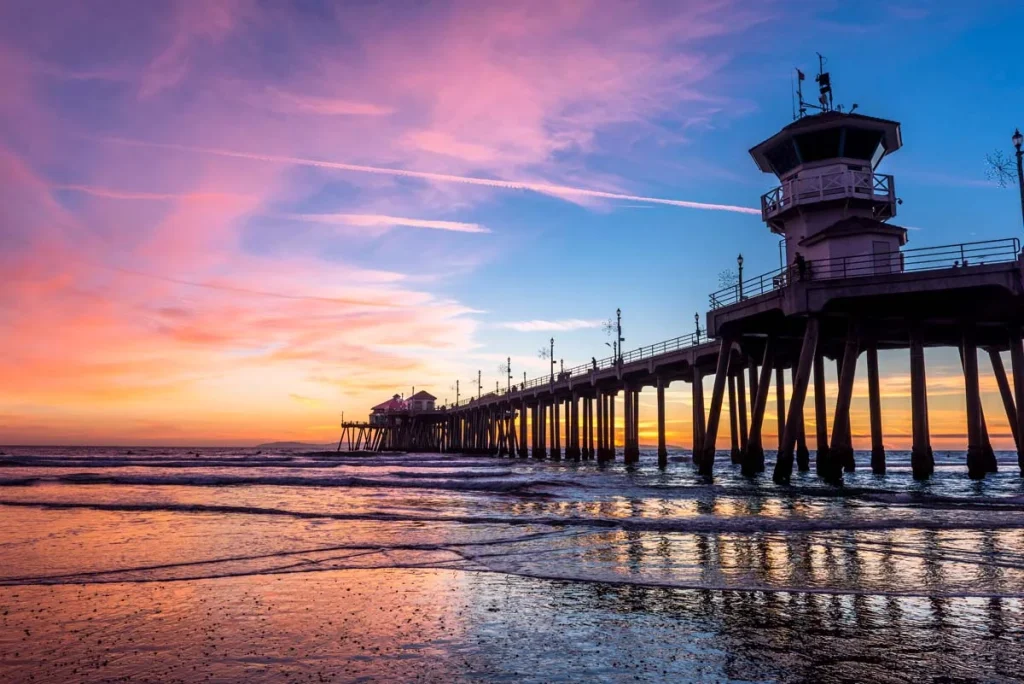 The iconic Huntington Beach Pier at sunset, a popular destination for Orange County short term rentals