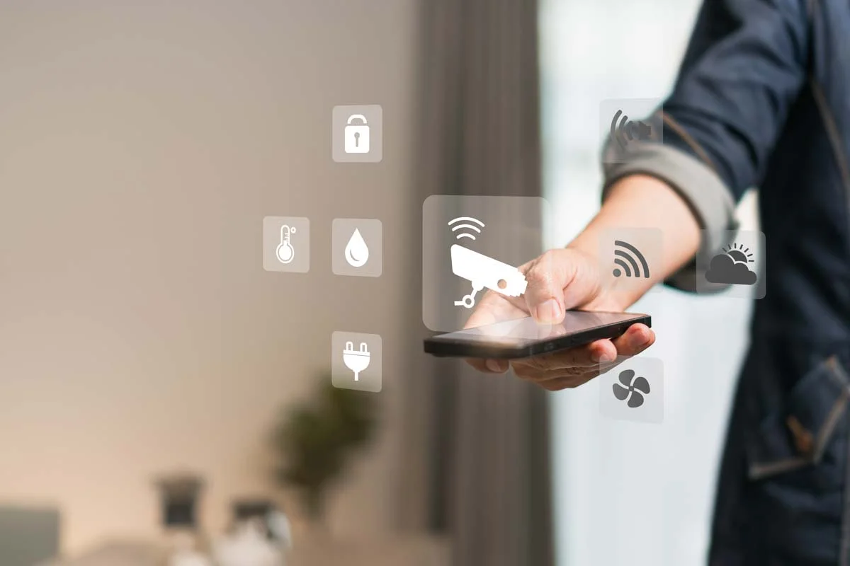 A host using Airbnb smart home automation tools on a smartphone to manage a vacation rental property