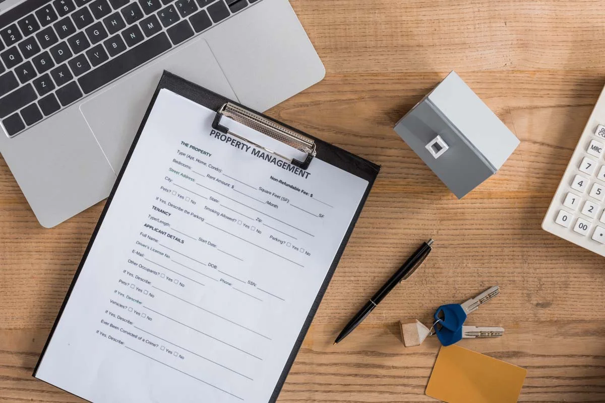 A laptop and house keys on a desk symbolizing professional Airbnb management in Chicago and regulatory compliance