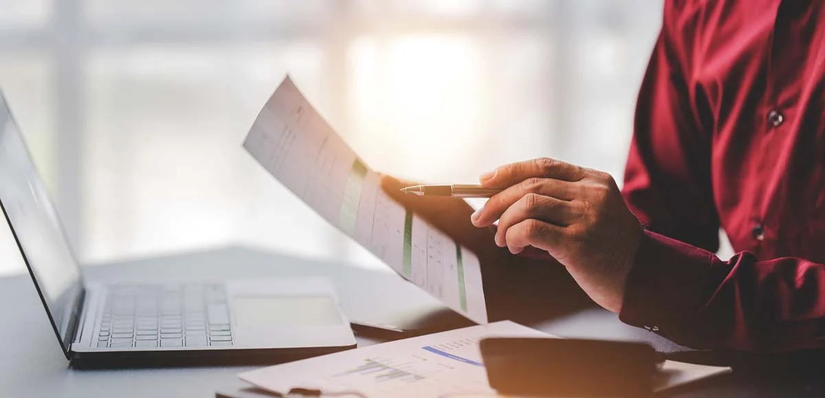 A property owner using a laptop to apply for a short term rental permit.