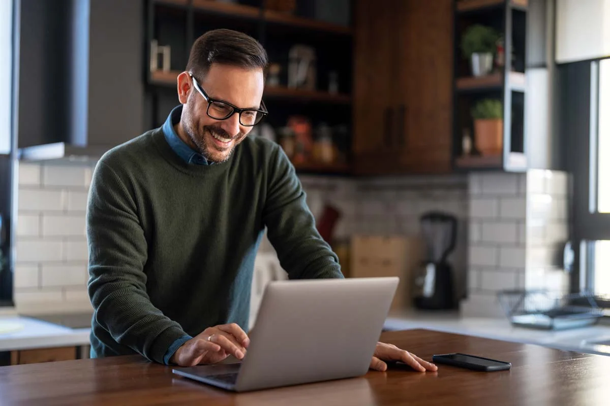 A property owner using a laptop to manage Fountain Hills short term rentals paperwork