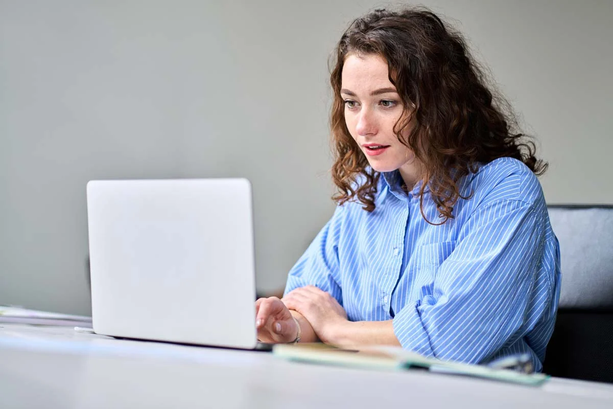 A property owner using a laptop to research how to get a business license for short term rentals in Richmond